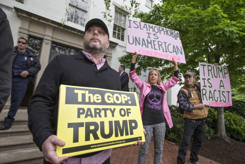 Anti-Trump protesters demonstrate against the GOP’s presumptive presidential nominee at the entrance of the Republican National Committee Headquarters on Capitol Hill in Washington, Thursday, May 12, 2016, as Donald Trump meets with House Speaker Paul Ryan of Wis. (AP Photo/J. Scott Applewhite)