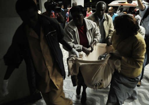 A wounded man is brought into the hospital after an attack at a bus station in Nairobi. Kenya faced a new terror threat after a grenade attack blamed on Somali Islamist militia killed six people and injured 63 in a bus terminal in the capital Nairobi