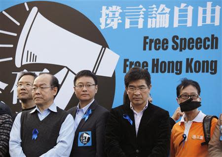 Protesters, including pro-democracy lawmakers, stand in front of a banner during a demonstration demanding for freedom of speech and press freedom in Hong Kong February 23, 2014. REUTERS/Bobby Yip