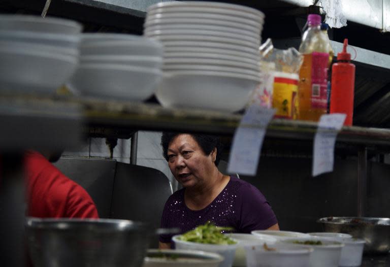 Businesswoman Monica Liu, a member of India's Chinese community, inspects the kitchen of her restaurant in Kolkata, on October 14, 2014