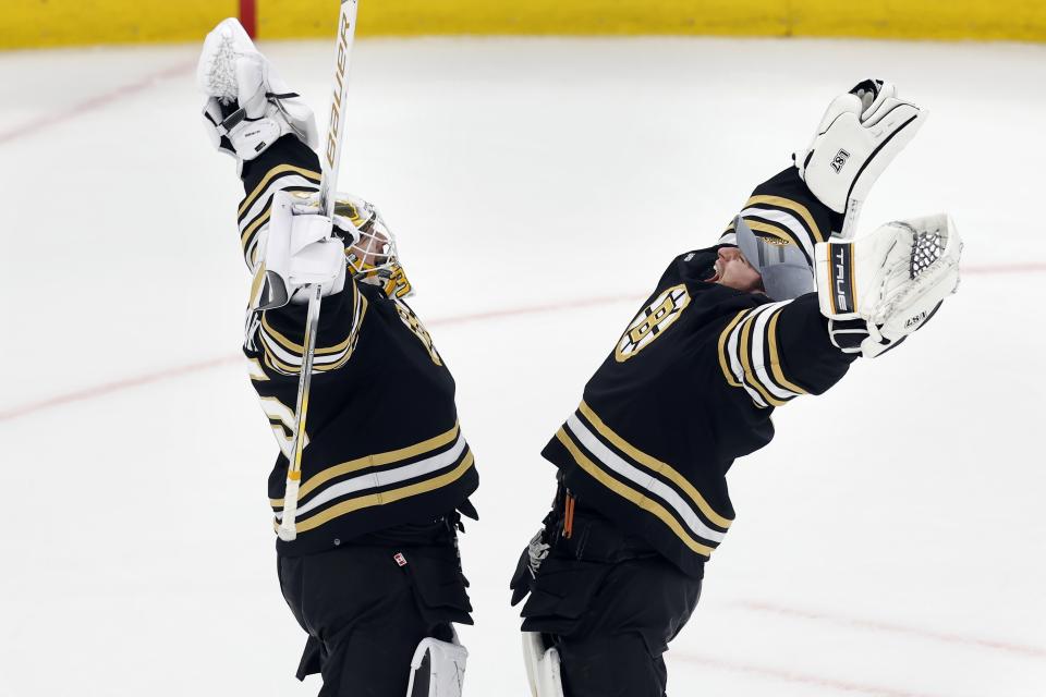 Boston Bruins' Linus Ullmark, left, and Jeremy Swayman celebrate after defeating the Arizona Coyotes during an NHL hockey game, Saturday, Dec. 9 2023, in Boston. (AP Photo/Michael Dwyer)