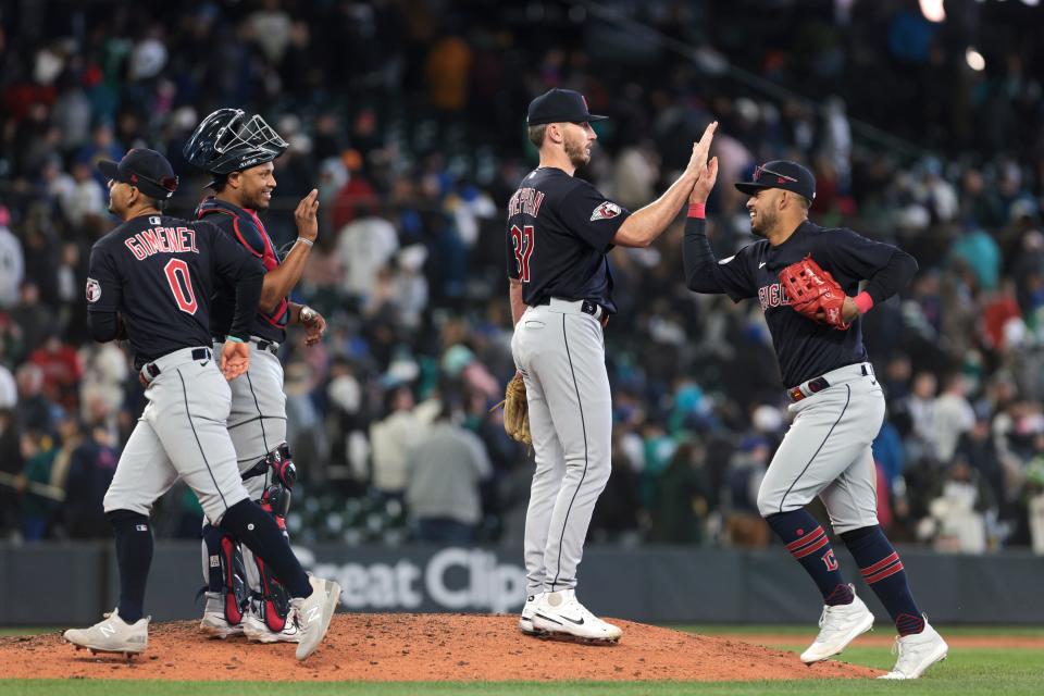 Cleveland Guardians catcher Meibrys Viloria, second from left, and relief pitcher Trevor Stephan (37) celebrate with second baseman Andres Gimenez (0) and third baseman Gabriel Arias, right, following the 10th inning against the Seattle Mariners, Sunday, April 2, 2023, in Seattle.