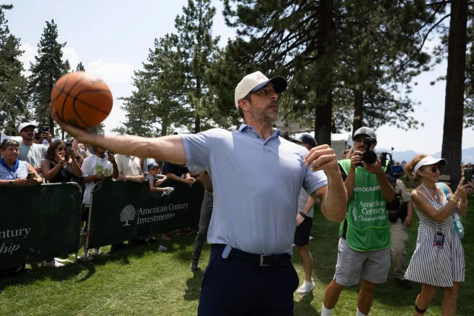 NFL quarterback Aaron Rodgers sends up a hook shot toward a basketball hoop set up near the 18th tee in the first round of the American Century celebrity golf championship on Friday, July 12, 2024, in Stateline, Nev.