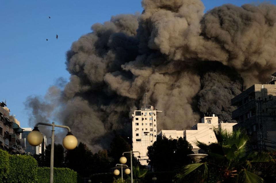 Heavy smoke rises from Shorouk Tower as it collapses