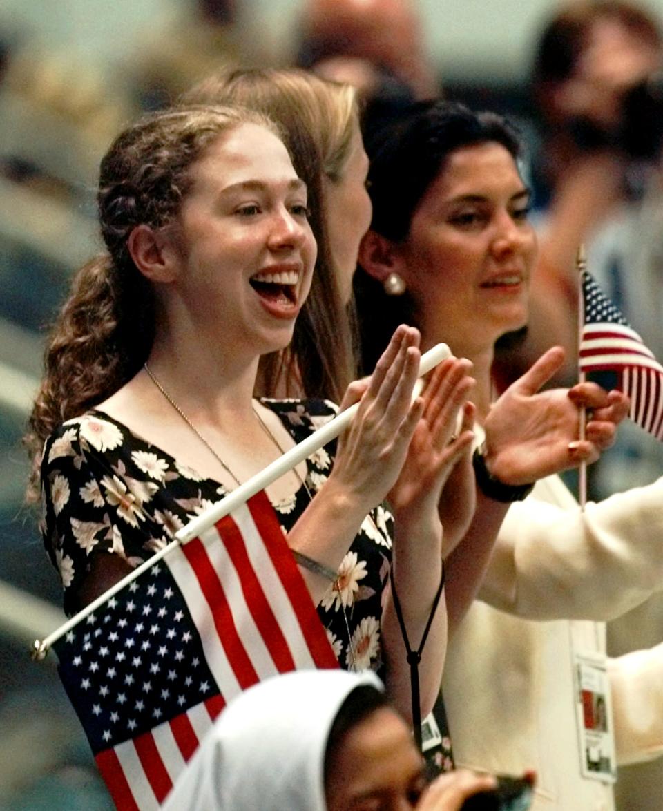 <p>Then just 16 years old, Chelsea Clinton applauds during the medal ceremony for the men’s 4×200 meter relay. (AP) </p>