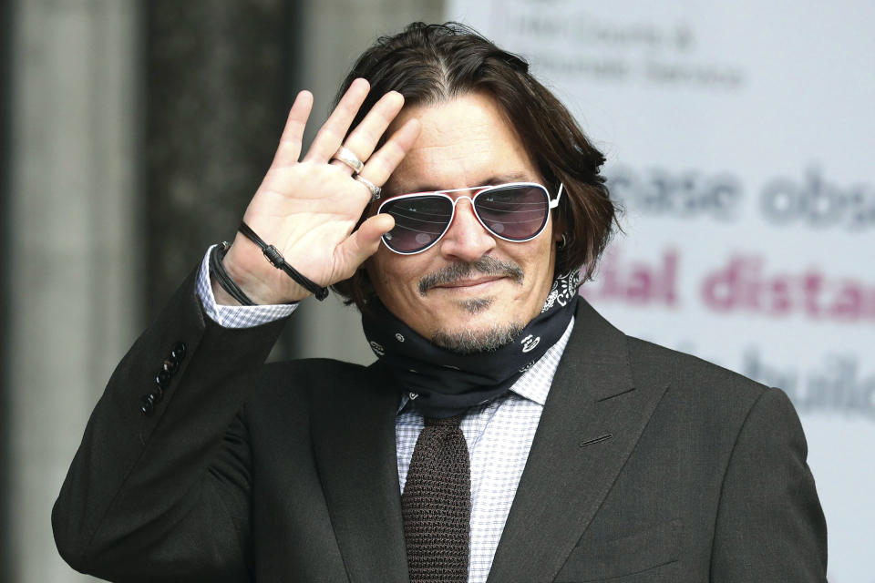 Actor Johnny Depp arrives at the High Court to give evidence in his libel case, in London, Wednesday July 15, 2020. Depp is suing News Group Newspapers, publisher of The Sun, and the paper’s executive editor, Dan Wootton, over an April 2018 article that called him a “wife-beater.” The Sun’s defense relies on a total of 14 allegations by Amber Heard of Depp’s violence. He strongly denies all of them. ( Jonathan Brady/PA via AP)