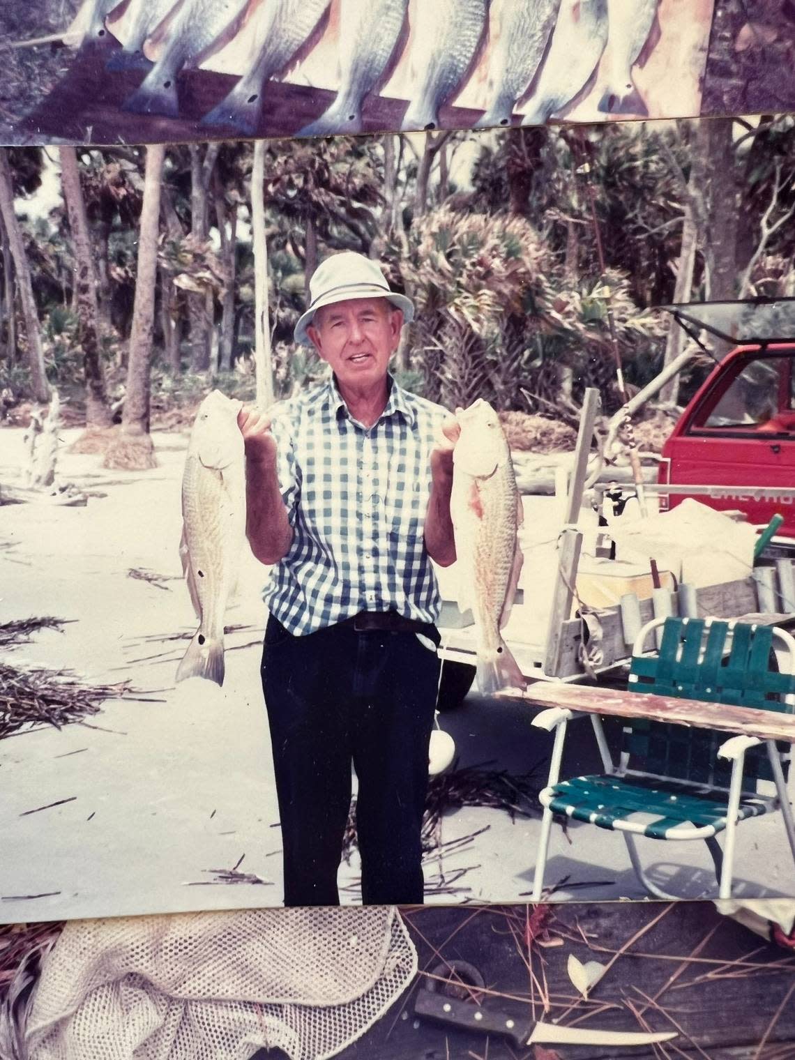 Philip Rhodes, donor of Pritchards Island, holding two fish on the Beaufort County barrier island in South Carolina.