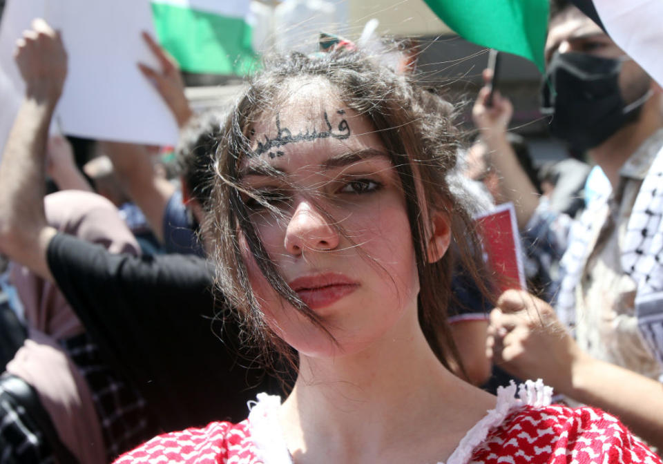 A young girl with 'Palestine' in Arabic letters written on her face is seen as Jordanians march in the downtown centre protesting in solidarity with Gazans during the current conflict with Israel, in Amman, Jordan. 