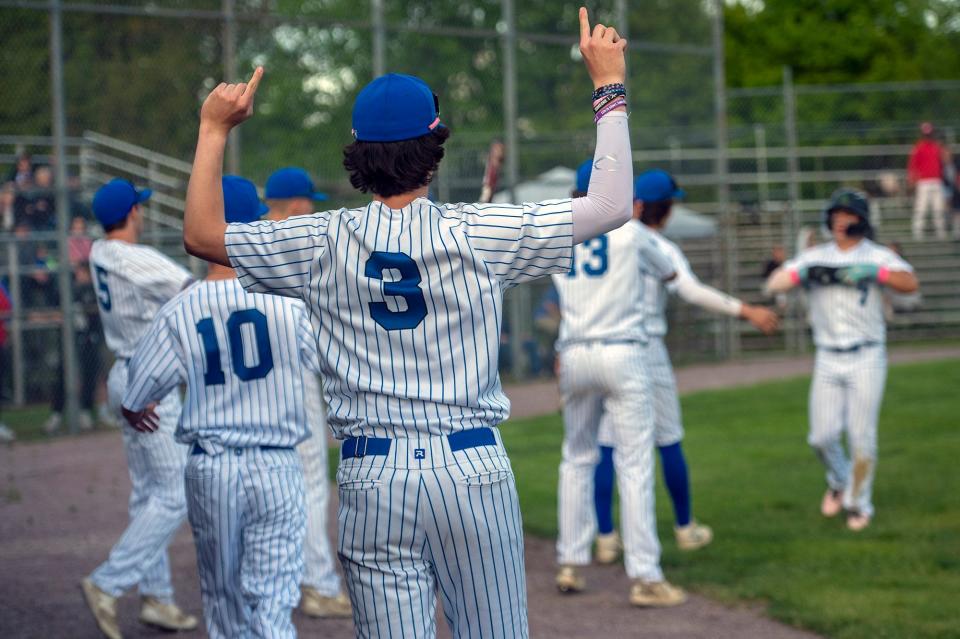 Hopedale High School junior Sean Sullivan, #3, welcomes runners who scored in the first inning against Milford, May 17, 2024.