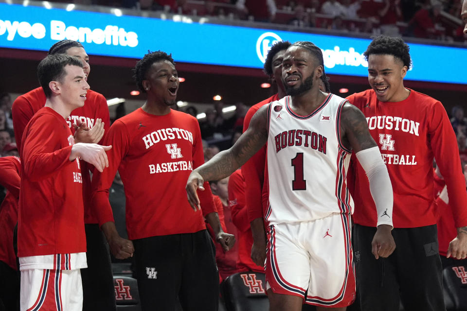 Houston's Jamal Shead (1) celebrates with teammates after making a basket while being fouled during the second half of an NCAA college basketball game against Kansas Saturday, March 9, 2024, in Houston. Houston won 76-46. (AP Photo/David J. Phillip)