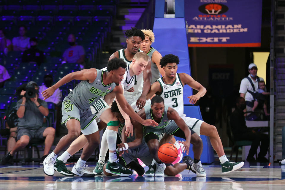 In this photo provided by Bahamas Visual Services, Baylor and Michigan State players vie for a loose ball during an NCAA college basketball game at Paradise Island, Bahamas, Friday, Nov. 26, 2021. (Tim Aylen/Bahamas Visual Services via AP)