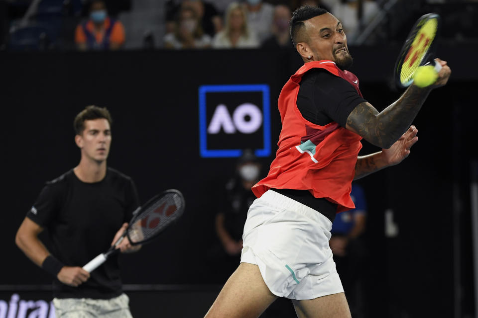 Nick Kyrgios, right, and Thanasi Kokkinakis of Australia play compatriots Matthew Ebden and Max Purcell in the men's doubles final at the Australian Open tennis championships in Saturday, Jan. 29, 2022, in Melbourne, Australia. (AP Photo/Andy Brownbill)