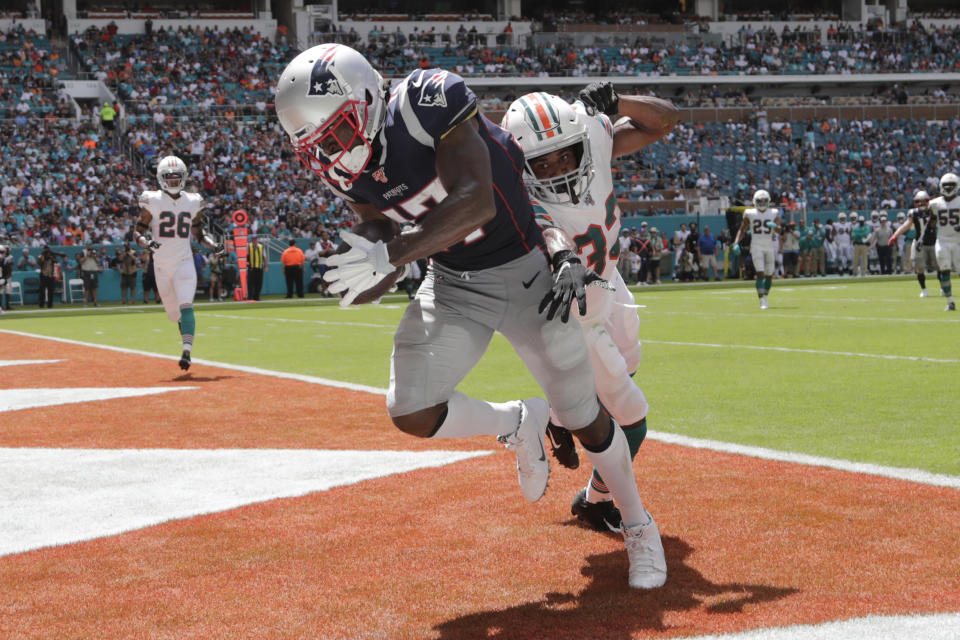 FILE - In this Sept. 15, 2019, file photo, then-New England Patriots wide receiver Antonio Brown (17) scores a touchdown as Miami Dolphins cornerback Jomal Wiltz (33) attempts to defend during the first half at an NFL football game, in Miami Gardens, Fla. Antonio Brown practices with the Tampa Bay Buccaneers for the first time, Wednesday, Nov. 4, 2020, and is eager to take advantage of his latest opportunity to continue his NFL career. (AP Photo/Lynne Sladky, File)