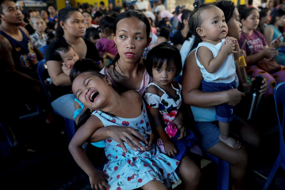 Mothers hold their children while waiting in line to receive free polio vaccine during a government-led mass vaccination program in Quezon City, Metro Manila, Philippines, October 14, 2019. REUTERS/Eloisa Lopez