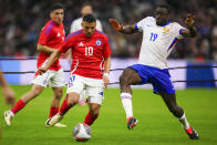 Chile's Alexis Sanchez, left, is challenged by France's Youssouf Fofana during an international friendly soccer match between France and Chile at the Orange Velodrome stadium in Marseille, southern France, Tuesday, March 26, 2024. (AP Photo/Daniel Cole)