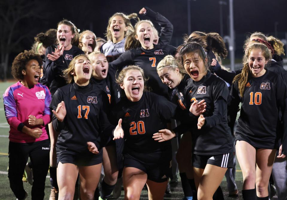 Oliver Ames players celebrate at the conclusion of their double overtime division two state semi-final game versus Grafton at Mansfield High School on Tuesday, Nov. 15, 2022.  