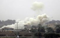 Smoke rises after an explosion during a military operation by Egyptian security forces in the Egyptian city of Rafah, near the border with southern Gaza Strip January 26, 2014. Egyptian security forces have stepped up a crackdown campaign since July 2013 on smuggling tunnels dug beneath the Gaza-Egypt border, Hamas officials said. (REUTERS/Ibraheem Abu Mustafa)