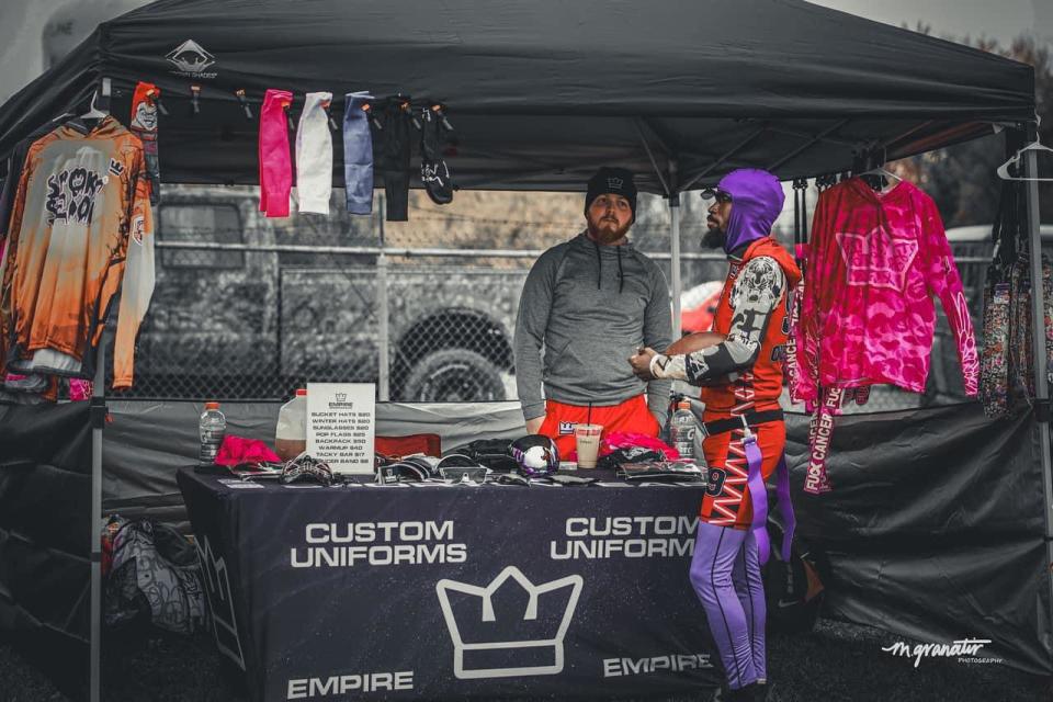 Empire Sportswear founder Kris Landin works a pop-up booth during a national flag football event.