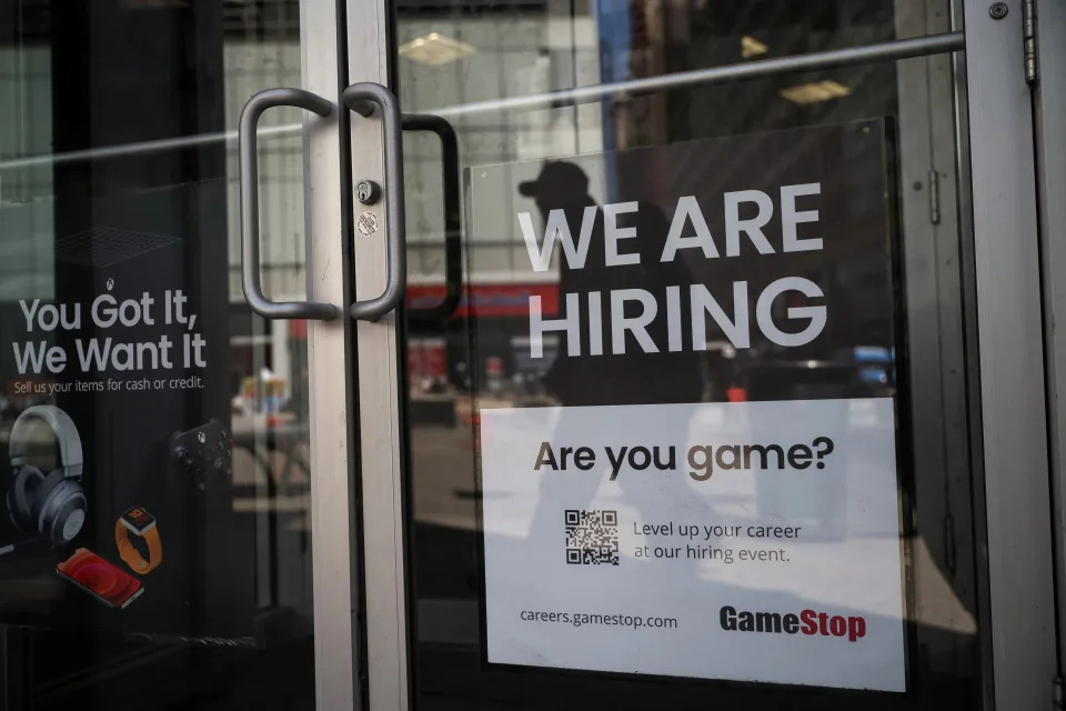 A sign for hire is posted on the door of a GameStop in New York City, U.S., April 29, 2022.  REUTERS/Shannon Stapleton