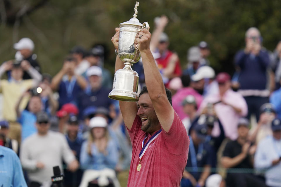 Jon Rahm, of Spain, holds the champions trophy after the final round of the U.S. Open Golf Championship, Sunday, June 20, 2021, at Torrey Pines Golf Course in San Diego. (AP Photo/Gregory Bull)