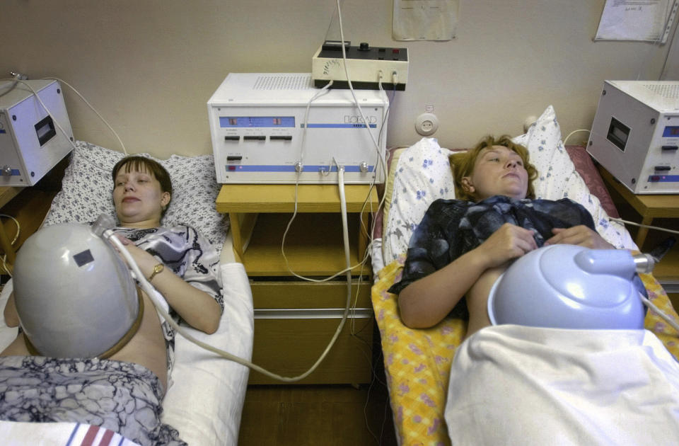 FILE - Two pregnant women undergo an examination in a family planning center in Yekaterinburg, Russia, on July 23, 2003. Over three decades, Russia went from having some of the world's least-restrictive abortion laws to being what officials call a bulwark of “traditional values,” with the health minister condemning women for prioritizing careers over childbearing. (Ural Press Photo via AP, File)