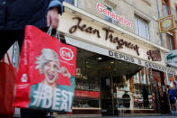 A woman walks past the Jean Trogneux, chocolate shop in Amiens, France, May 16, 2019. REUTERS/Pascal Rossignol