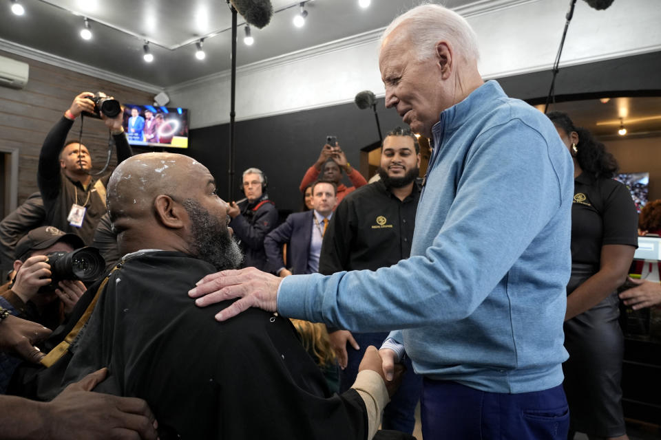 President Joe Biden, right, greets a patron at the Regal Lounge barber shop in Columbia, S.C., Saturday, Jan. 27, 2024. Biden is going small to try to win big in November. With 10 months to go until Election Day, the Democratic incumbent is all in on minimalist events — visits to a boba tea store, a family's kitchen and a barbershop, for example — rather than big rallies.(AP Photo/Jacquelyn Martin, File)