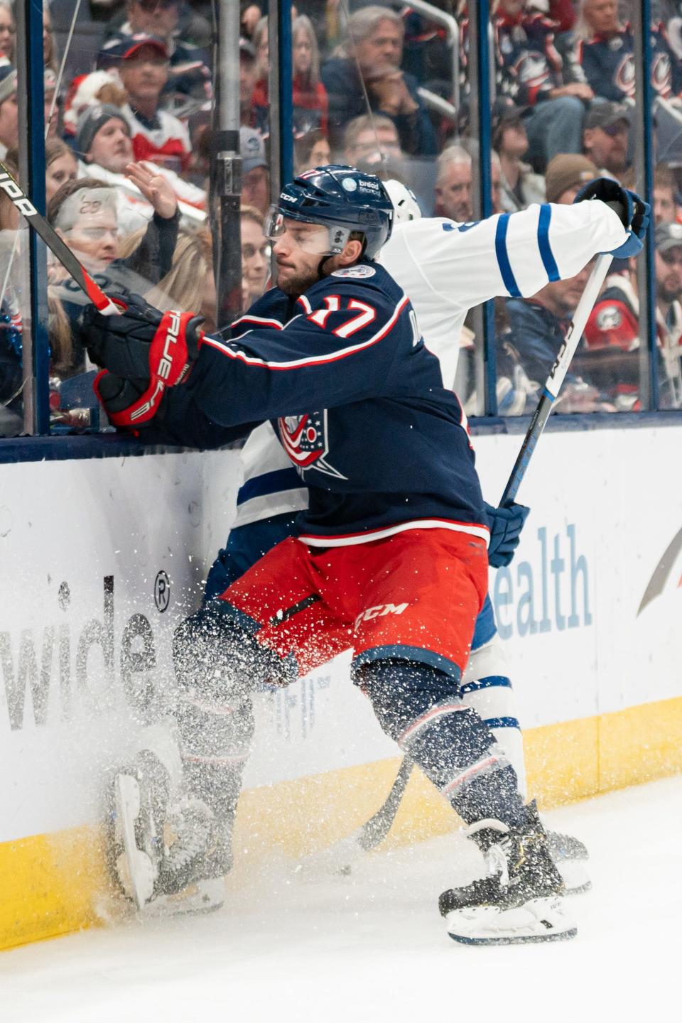 Dec 23, 2023; Columbus, Ohio, USA;
Columbus Blue Jackets right wing Justin Danforth (17) slams Toronto Maple Leafs defenseman William Lagesson (85) against the wall during the third period of their game on Saturday, Dec. 23, 2023 at Nationwide Arena.