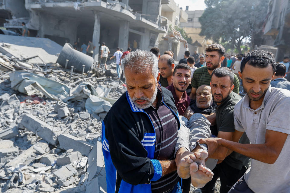 A wounded man is carried following Israeli strikes on Rafah.