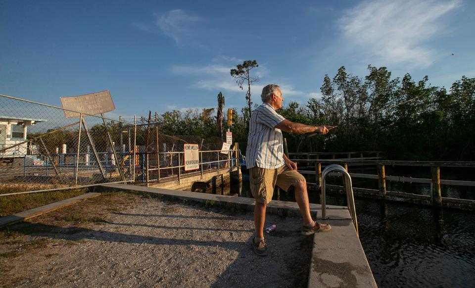 Dave Lipiro, visiting from Ohio, casts his fishing rod near the Chiquita lock in Cape Coral Wednesday, March 1, 2023. The lock has been non-operational since being damaged by the impact of Hurricane Ian late September of last year.  