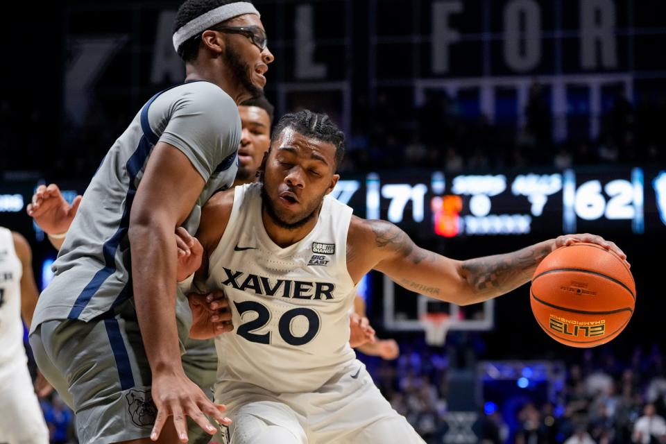 Xavier Musketeers guard Dayvion McKnight (20) drives against Butler Bulldogs center Andre Screen (23) in the second half of the NCAA Big East basketball game between the Xavier Musketeers and the Butler Bulldogs at the Cintas Center in Cincinnati on Tuesday, Jan. 16, 2024. The Musketeers won 85-71.