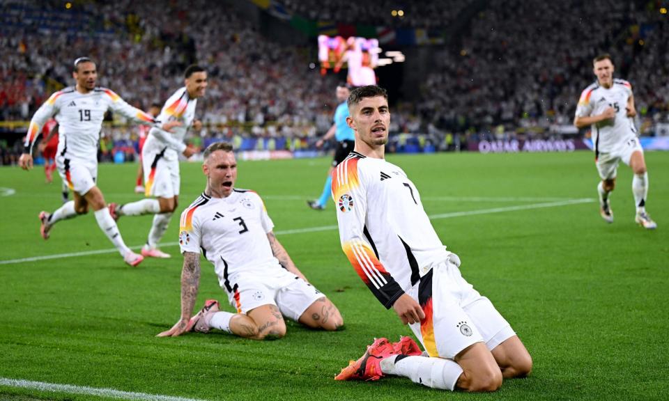 <span>Kai Havertz is chased by his Germany teammates after scoring the opening goal against Denmark.</span><span>Photograph: Shaun Botterill/Getty Images</span>
