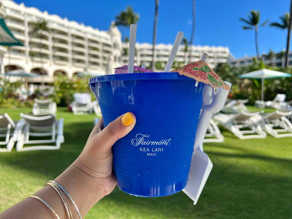blue bucket cocktail being held by ashley probst