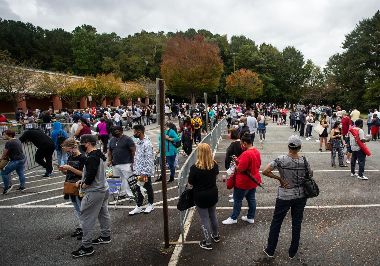 <span class="caption">In 2020, Georgia voters lined up for long waits to cast early ballots.</span> <span class="attribution"><a class="link " href="https://newsroom.ap.org/detail/ExplainingUSVotingBillsGeorgia/e7444661453c4e02af6a19cd03f1635f/photo" rel="nofollow noopener" target="_blank" data-ylk="slk:AP Photo/Ron Harris;elm:context_link;itc:0;sec:content-canvas">AP Photo/Ron Harris</a></span>