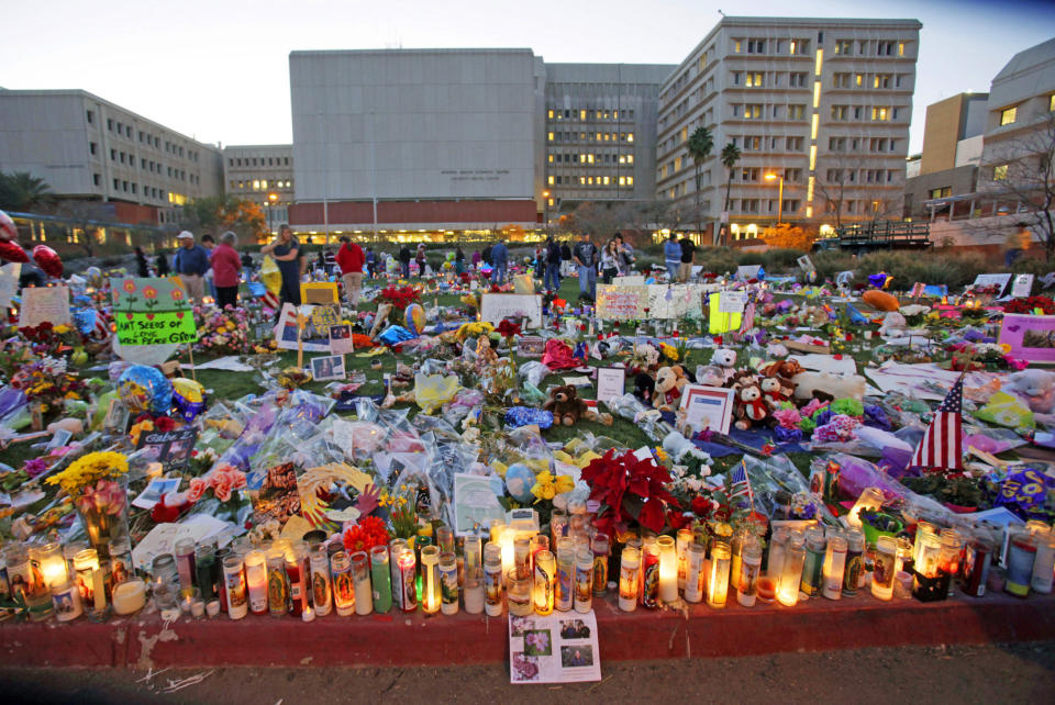 FILE - In this Jan. 18, 2011, file photo, impromptu memorials to the victims of a mass shooting in Tucson, Ariz., that left multiple people dead and over a dozen wounded, including then U.S. Rep. Gabrielle Giffords are displayed outside University Medical Center in Tucson, Ariz. The Giffords group and March For Our Lives, two prominent gun safety organizations say they'll host a forum for Democratic presidential candidates in Las Vegas on Oct. 2, 2019, the day after the second anniversary of the Las Vegas mass shooting. The organizations told The Associated Press that the forum focused on gun violence is the first of its kind for presidential hopefuls. (David Sanders/Arizona Daily Star via AP, File)