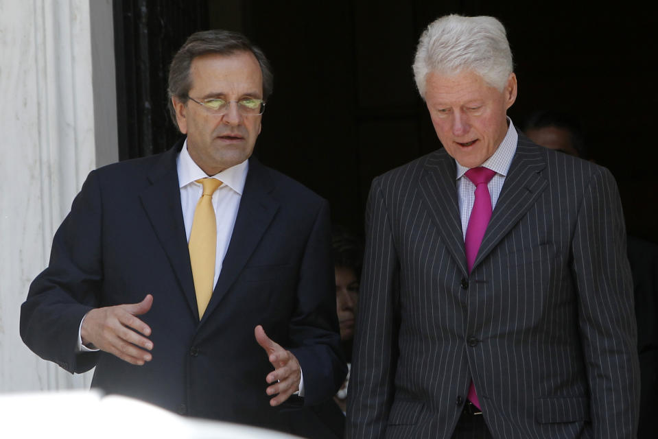 Greek Prime Minister Antonis Samaras, left, and Former U.S. President Bill Clinton leave Maximos mansion after their meeting in Athens, Sunday, July 22, 2012. Clinton is in Greece to promote the "Hellenic Initiative," an initiative by businessmen of Greek origin living abroad who want to facilitate foreign investment in the debt-ridden country and to raise (Canadian) $100 million to help charities active in Greece. (AP Photo)