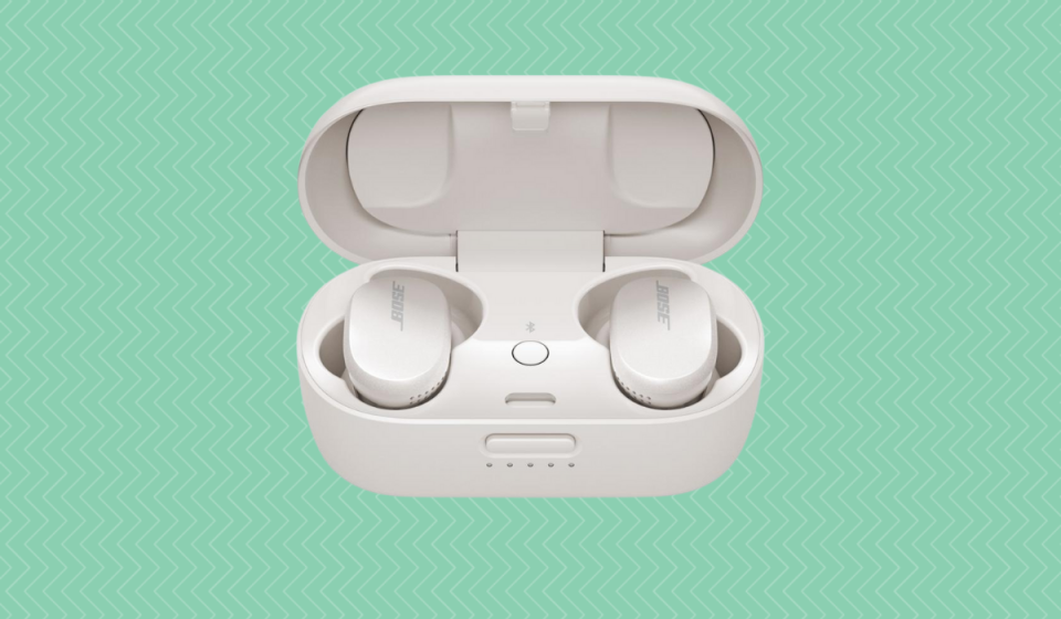 Bose earbuds in white wireless charging case. 