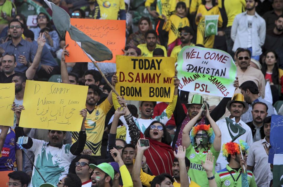 Pakistani cricket fans celebrate the final of Pakistan Sports League at the Gaddafi Stadium, in Lahore, Pakistan, Sunday, March 5, 2017. West Indies World Twenty20 winning captain Darren Sammy was among nine foreign cricketers to arrive in Lahore early Sunday as extraordinary security measures were put in place around Gaddafi Stadium to ensure a peaceful Pakistan Super League final.(AP Photo/K.M. Chaudary)