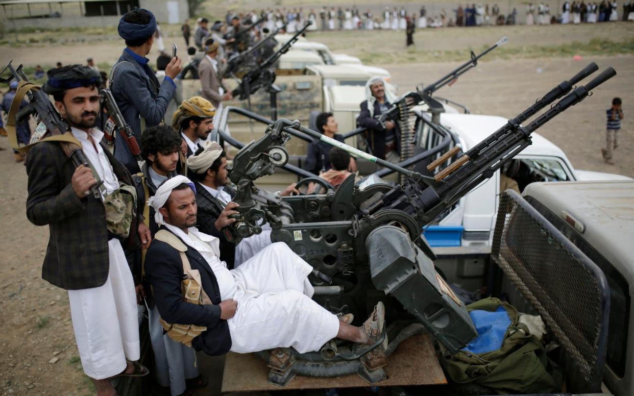 Houthi rebel fighters ride on trucks mounted with wepons, during a gathering aimed at mobilizing more fighters for the Houthi movement - AP