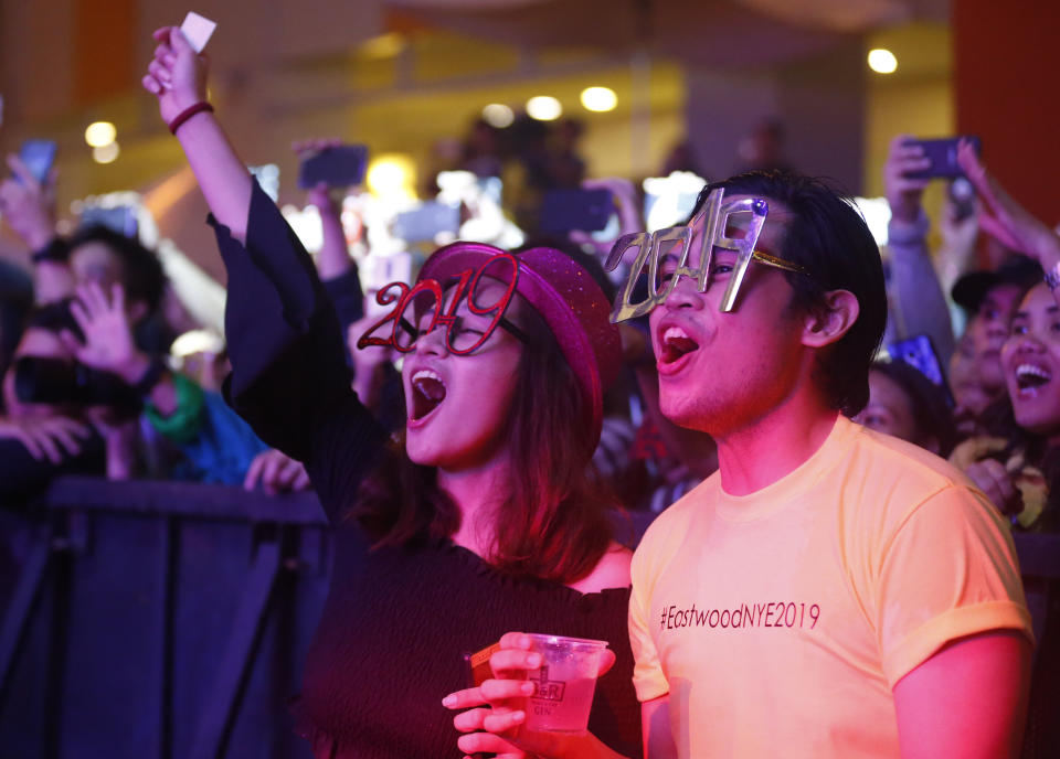 Filipinos cheer during a New Year countdown at the Eastwood Shopping Mall late Monday, Dec. 31, 2018 in suburban Quezon city northeast of Manila, Philippines. Filipinos welcome the New Year with the loudest noise possible including setting off powerful firecrackers in one of Asia's most violent celebrations