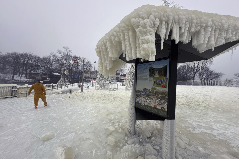 Mist from the Great Falls has created a frozen wonderland around the waterfalls in Paterson, N.J., on Thursday, Jan. 18, 2024. People are braving the subfreezing cold temps and slippery walkways to visit the ice-covered trees, benches and lamposts. (AP Photo/Ted Shaffrey)