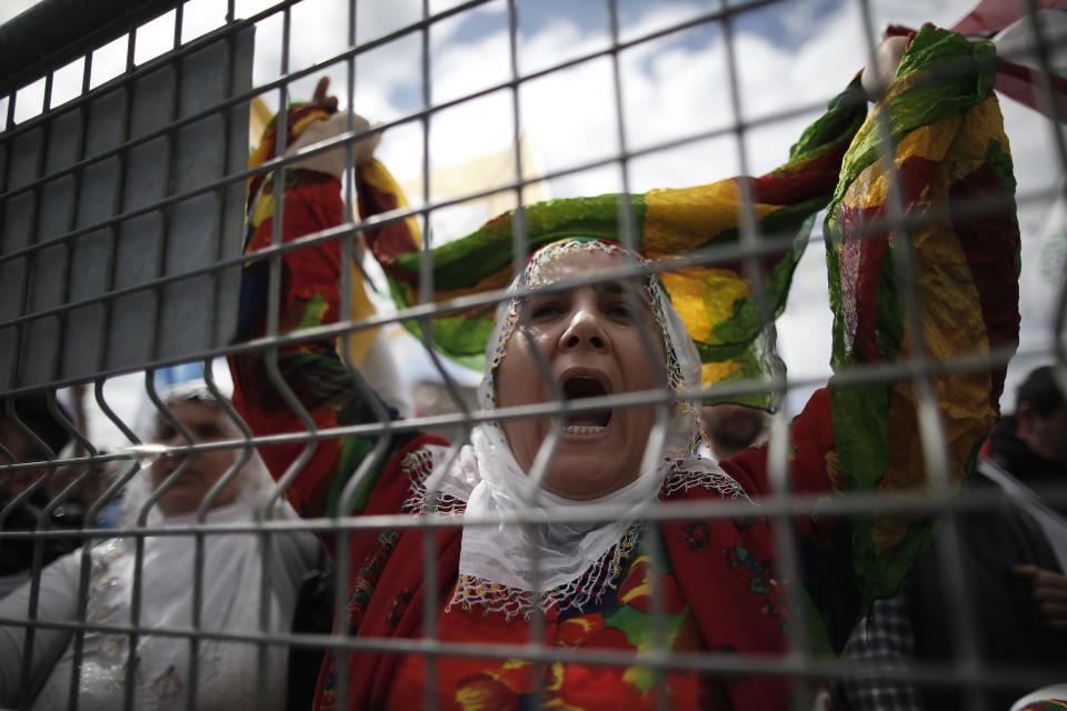 A woman shouts as thousands of supporters of pro-Kurdish Peoples' Democratic Party, or HDP, gather to celebrate the Kurdish New Year and to attend a campaign rally for local elections that will test the Turkish president's popularity, in Istanbul, Sunday, March 24, 2019. The HDP held the event amid the municipal office races that have become polarizing and a government crackdown on its members for alleged links to outlawed Kurdish militants. (AP Photo/Emrah Gurel)