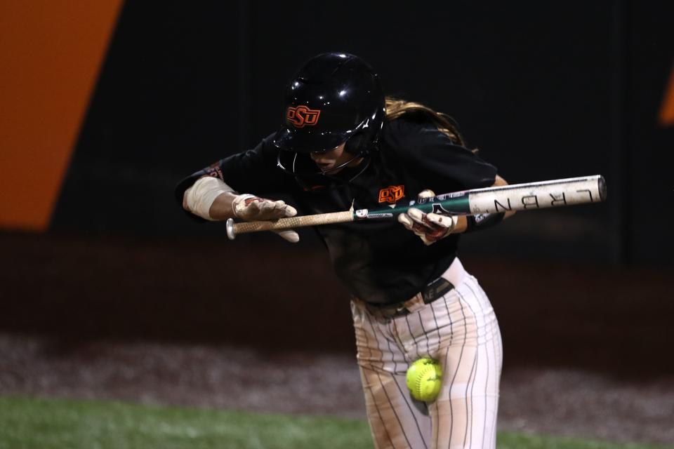 Oklahoma State’s Scotland David is hit by a pitch during a fall softball game against Seminole State College in Stillwater, Okla. on Tuesday, Oct. 10, 2023.