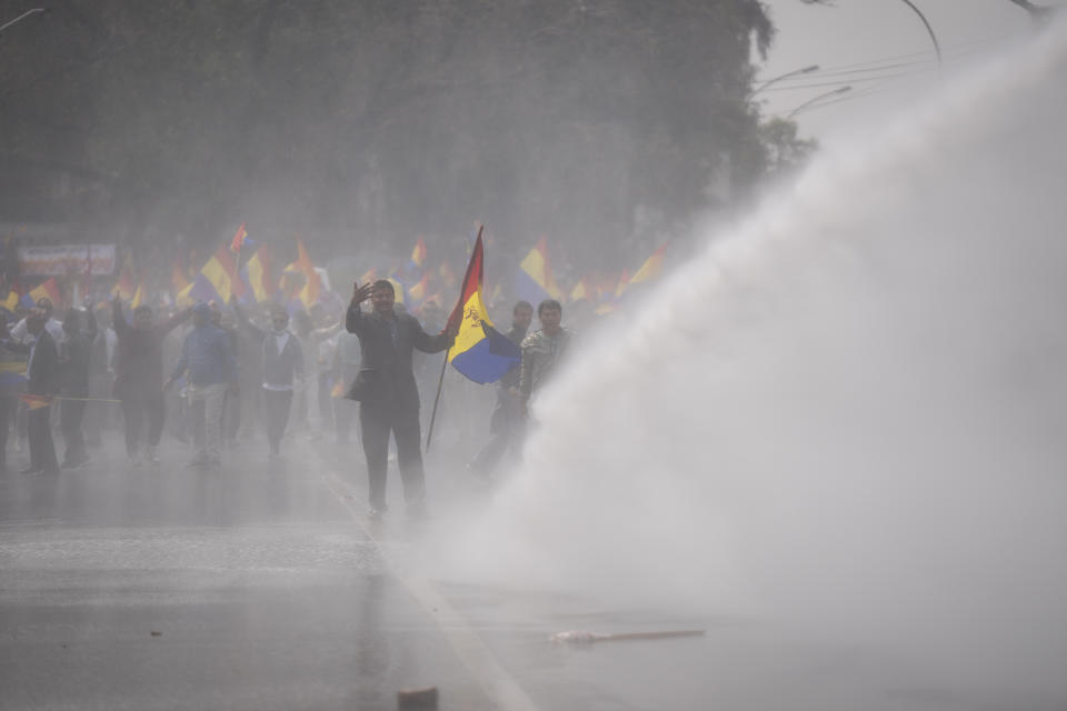 Nepalese police use water cannon to disperse supporters of Rastriya Prajatantra Party, or national democratic party during a protest demanding a restoration of Nepal's monarchy in Kathmandu, Nepal, Tuesday, April 9, 2024. Riot police used batons and tear gas to halt thousands of supporters of Nepal's former king demanding the restoration of the monarchy and the nation's former status as a Hindu state. Weeks of street protests in 2006 forced then King Gyanendra to abandon his authoritarian rule and introduce democracy. (AP Photo/Niranjan Shrestha)