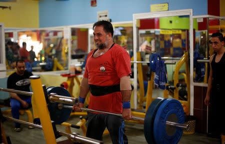 A Palestinian man lifts weights in a gym in Gaza City. REUTERS/Suhaib Salem