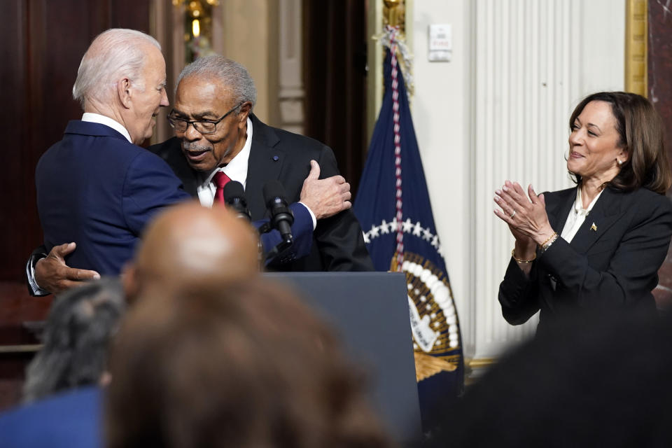 President Joe Biden hugs Rev. Wheeler Parker, Jr., as Vice President Kamala Harris applauds, at an event to establish the Emmett Till and Mamie Till-Mobley National Monument, in the Indian Treaty Room in the Eisenhower Executive Office Building on the White House campus, Tuesday, July 25, 2023, in Washington. (AP Photo/Evan Vucci)