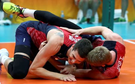 2016 Rio Olympics - Volleyball - Final - Men's Bronze Medal Match USA v Russia - Maracanazinho - Rio de Janeiro, Brazil - 21/08/2016. Matt Anderson (USA) of USA and Maxwell Holt (USA) of USA celebrate at the end of the match. REUTERS/Yves Herman