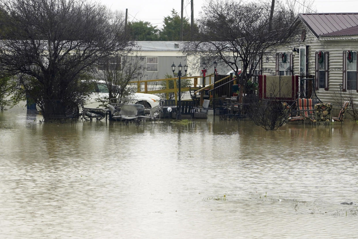 A mobile home community in Ruleville, Miss., is flooded from torrential rains that accompanied destructive storms that ripped across the U.S., spawning tornadoes that killed a young boy and his mother in Louisiana, smashed mobile homes and chicken houses in Mississippi and threatened neighboring Southern states with additional severe weather Wednesday, Dec. 14, 2022. (AP Photo/Rogelio V. Solis)