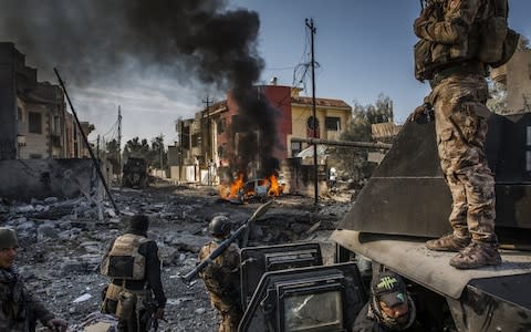 Iraqi Special Forces soldiers surveyed the aftermath of an Isil suicide car bomb that managed to reach their lines in the Andalus neighbourhood, one of the last areas to be liberated in east Mosul - Credit: Ivor Prickett/The New York Times&nbsp;