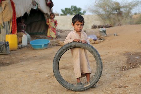 A boy stands outside his family's hut at the Shawqaba camp for internally displaced people who were forced to leave their villages by the war in Yemen's northwestern province of Hajjah March 13, 2016. REUTERS/Abduljabbar Zeyad